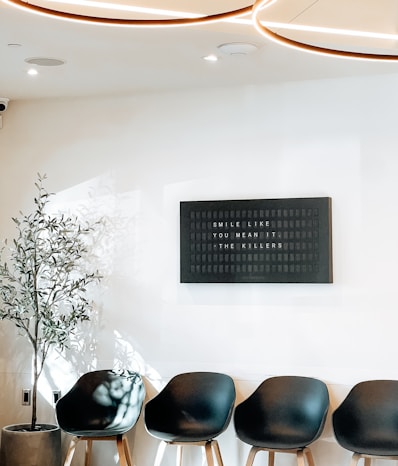Modern waiting room with chairs and inspirational sign.