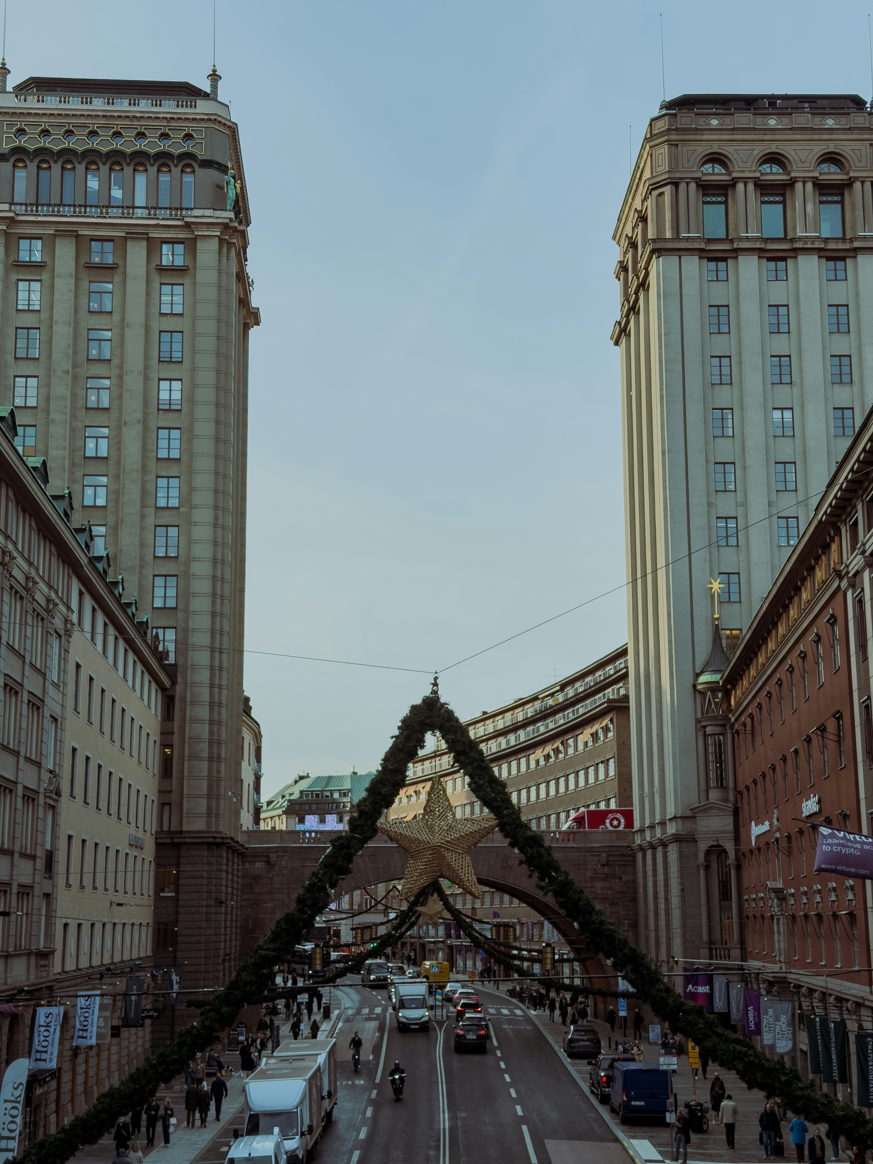 City street with festive decorations and traffic.