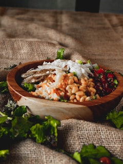 A wooden bowl filled with a healthy grain salad.