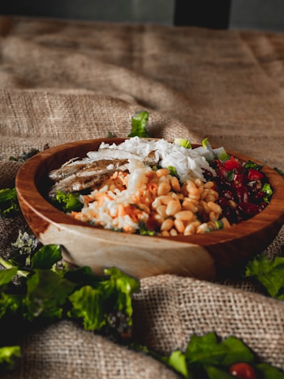 A wooden bowl filled with a healthy grain salad.