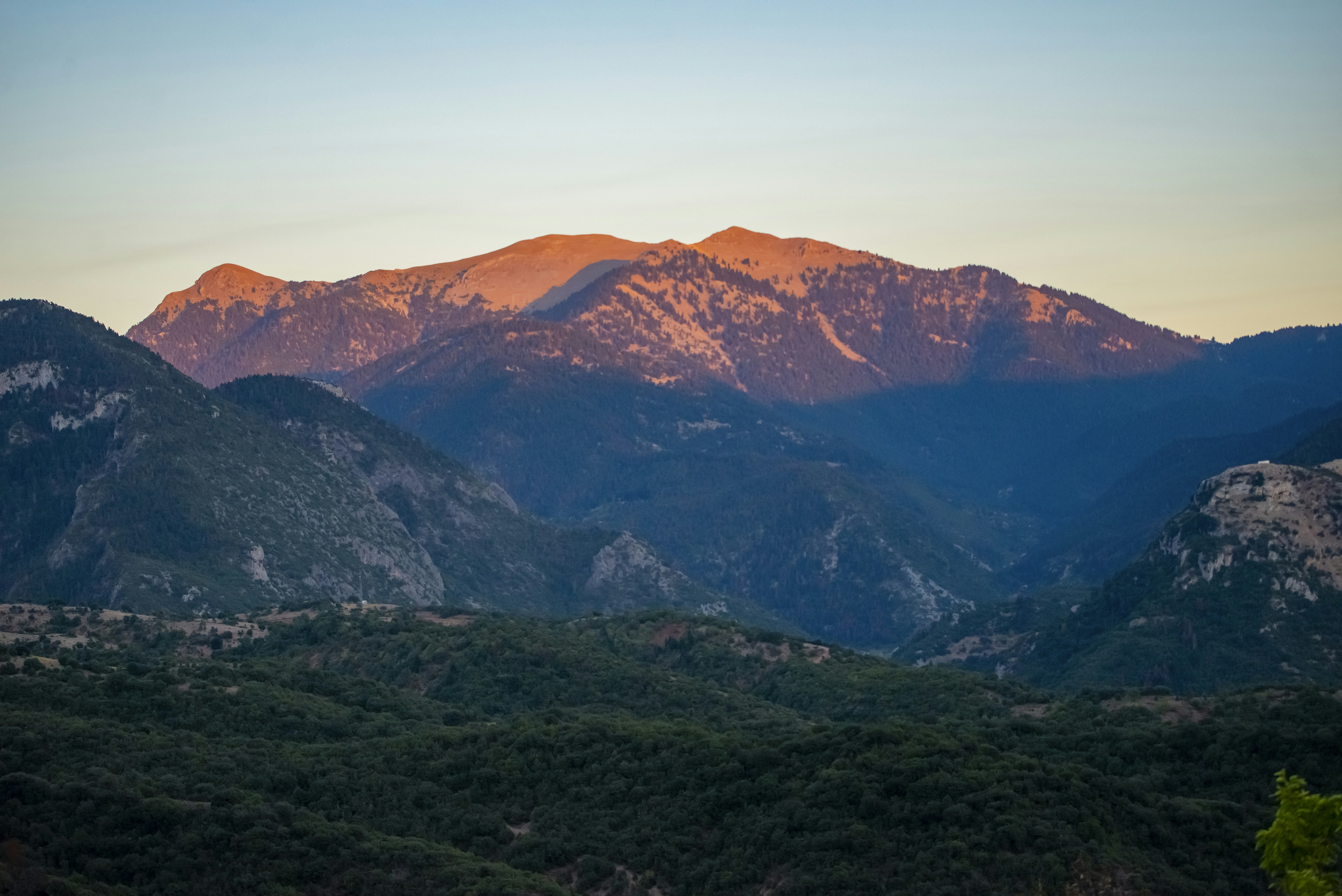 Majestic mountain range bathed in golden sunset light.