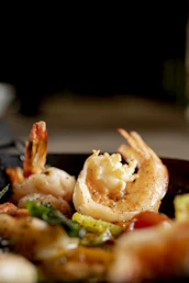 Close-up of cooked shrimp with vegetables on a plate