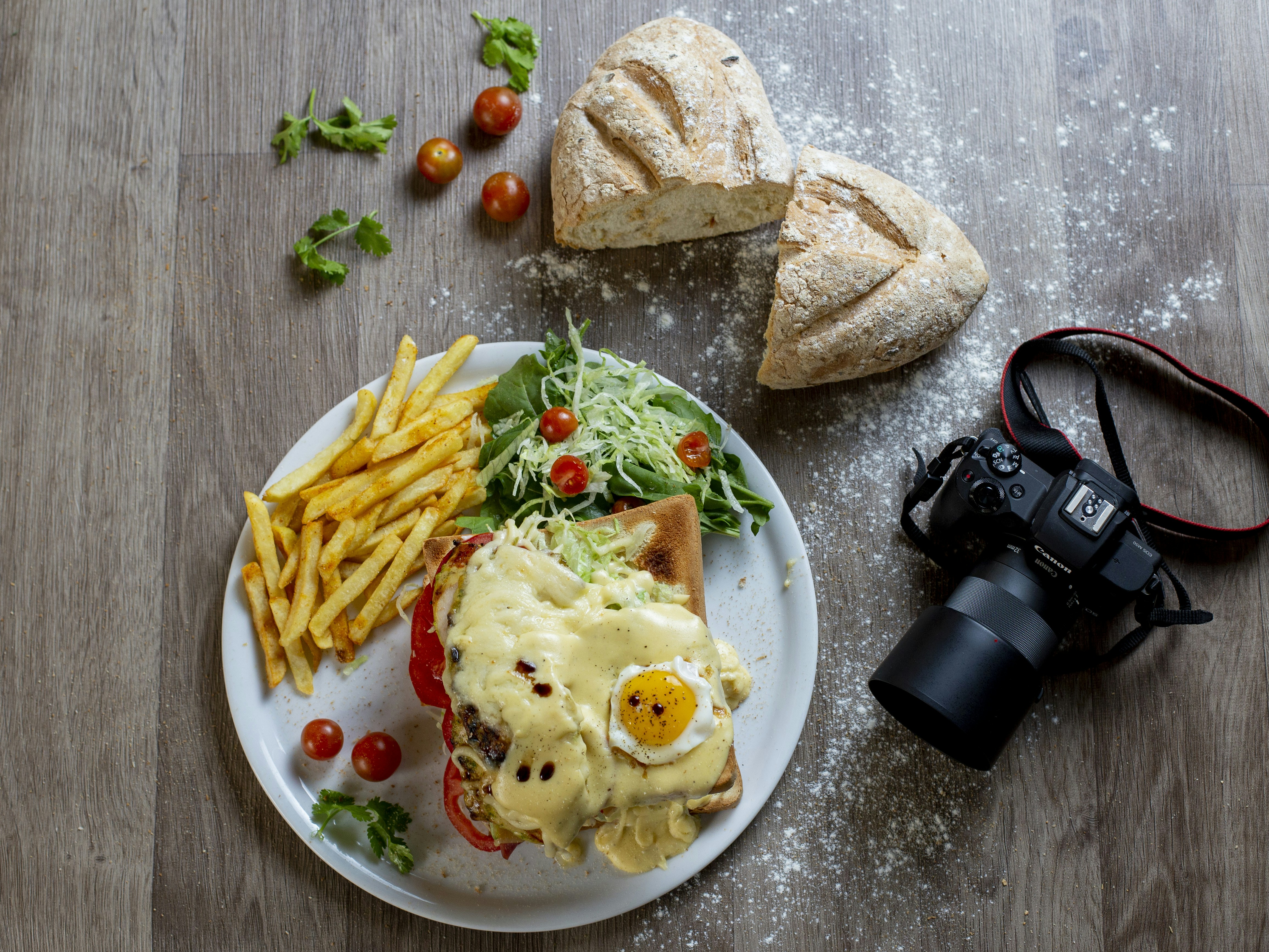 Hearty meal with fries, salad, and a camera