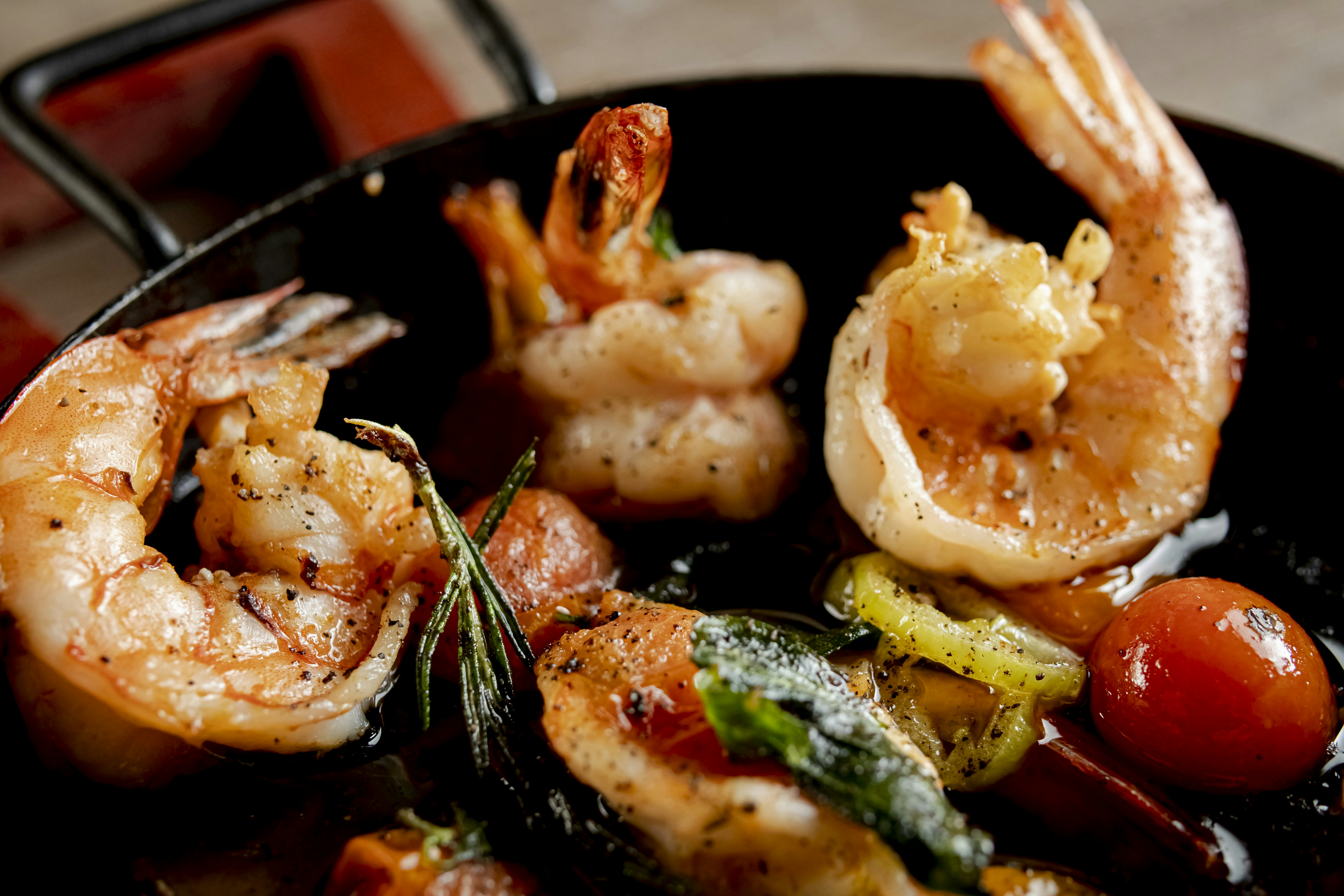 Cooked shrimp and vegetables in a pan