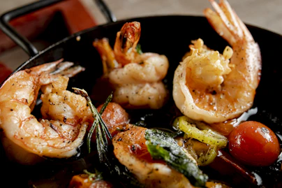 Cooked shrimp and vegetables in a pan