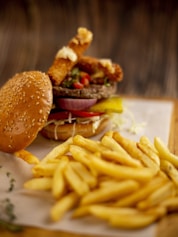 Juicy burger with fries on a wooden table