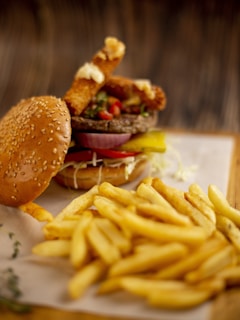Juicy burger with fries on a wooden table