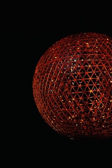 A glowing red geometric sphere on a black background.
