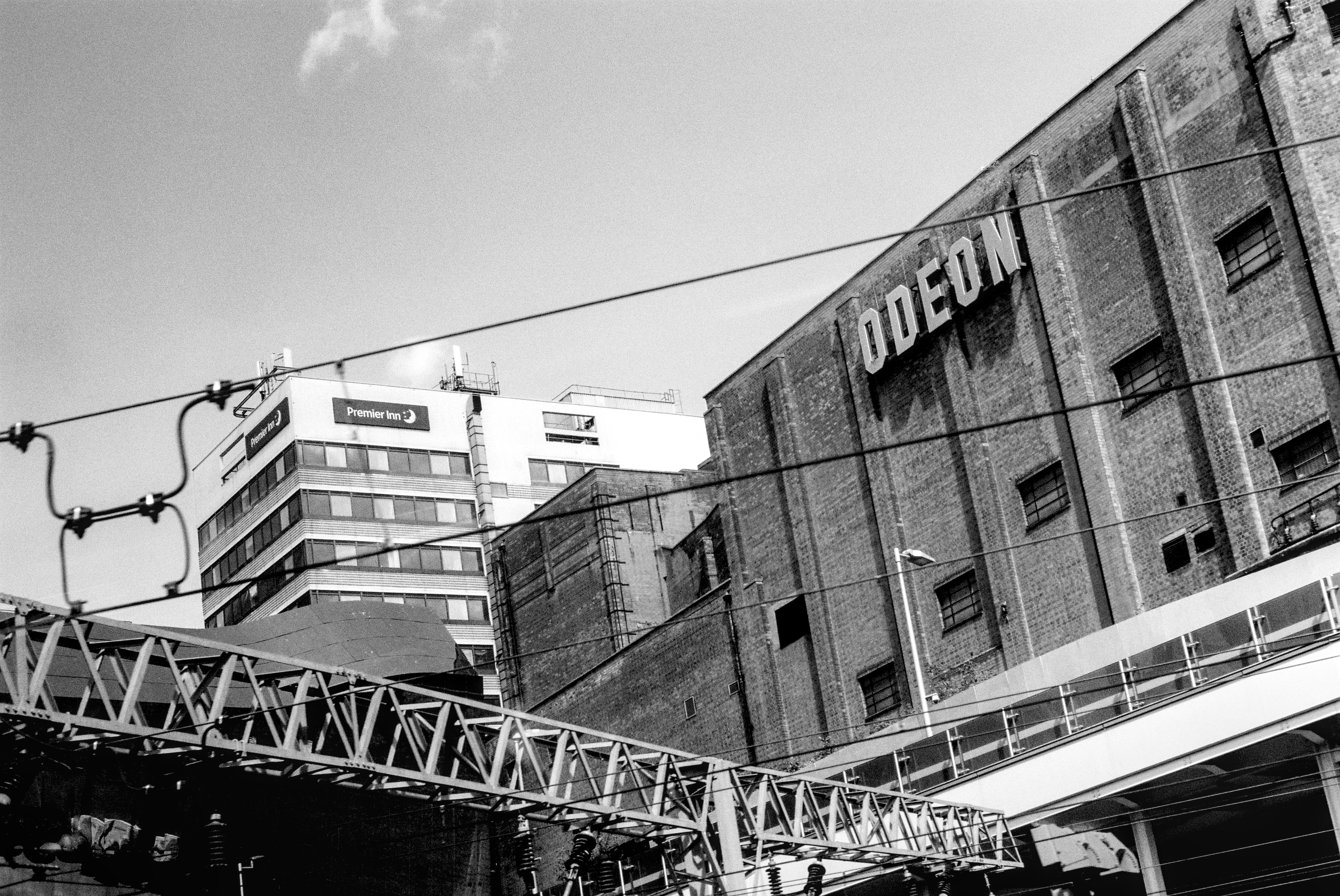 Brick odeon building with modern structures nearby