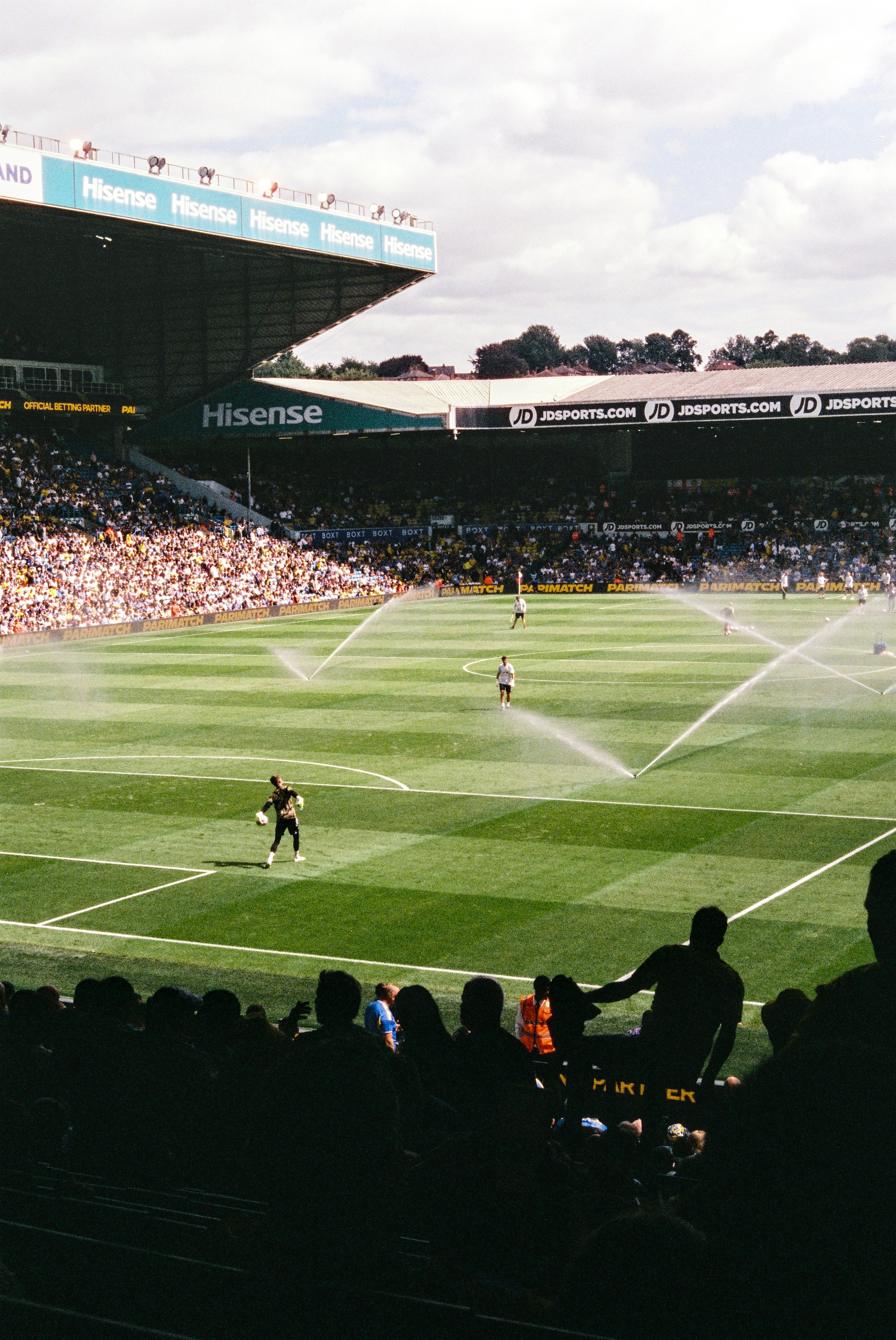 Soccer field being watered during a match.