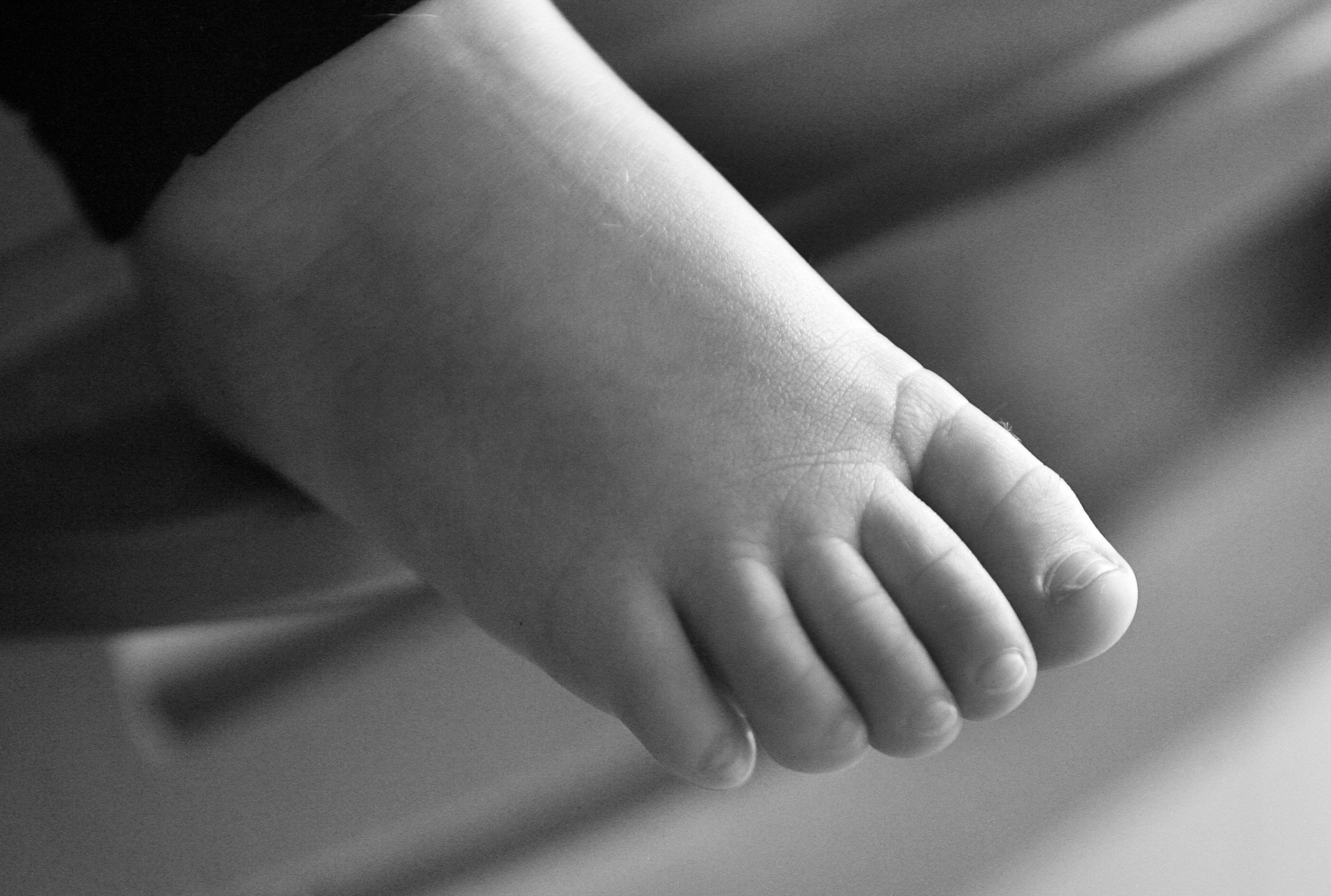Close-up of a baby's foot in black and white