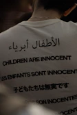 White shirt with text in multiple languages about innocence