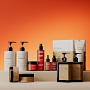 Assortment of skincare products on orange background