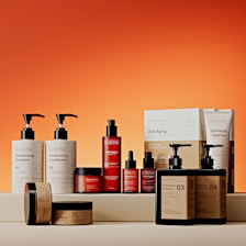 Assortment of skincare products on orange background