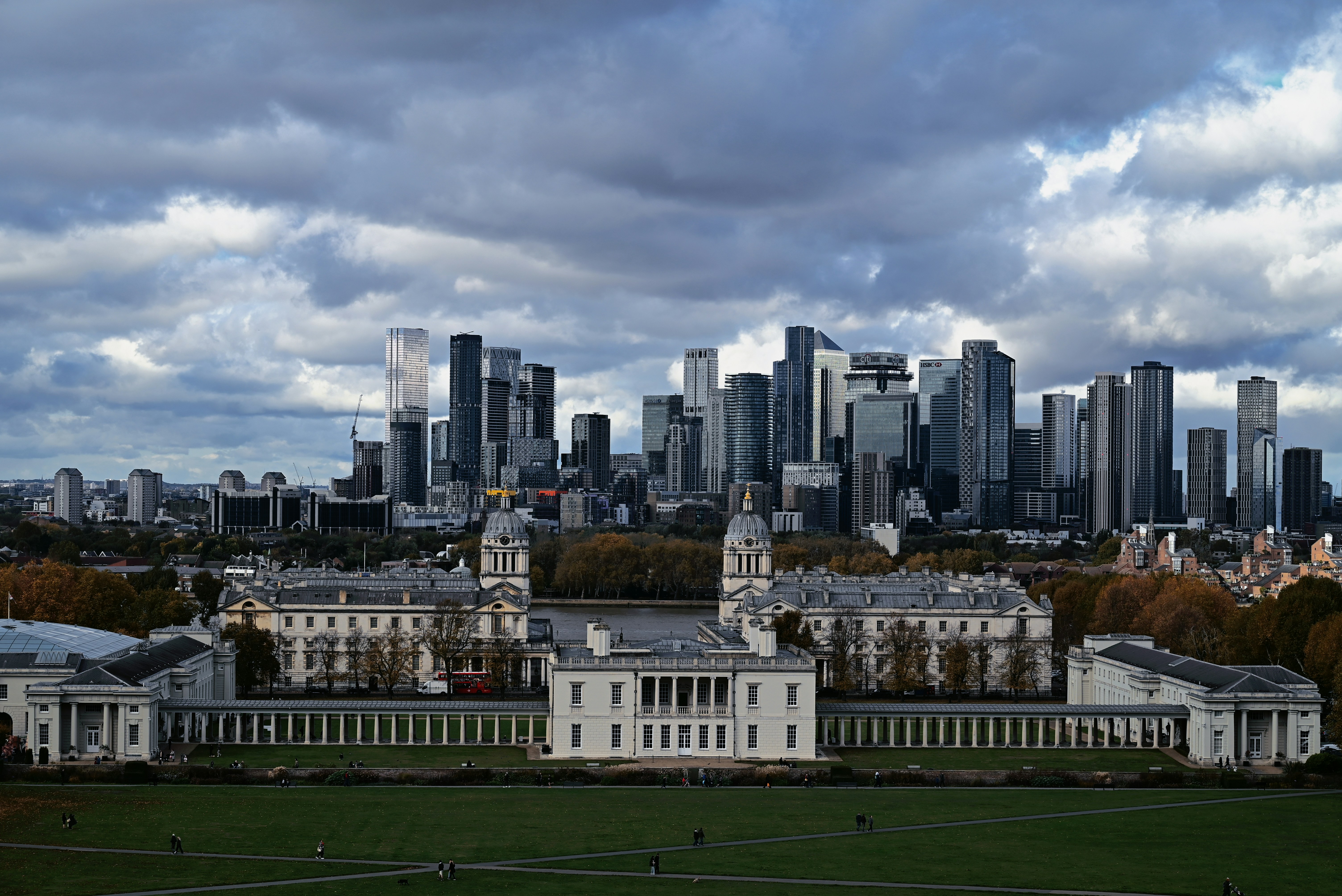 Historic buildings with modern skyscrapers in background.