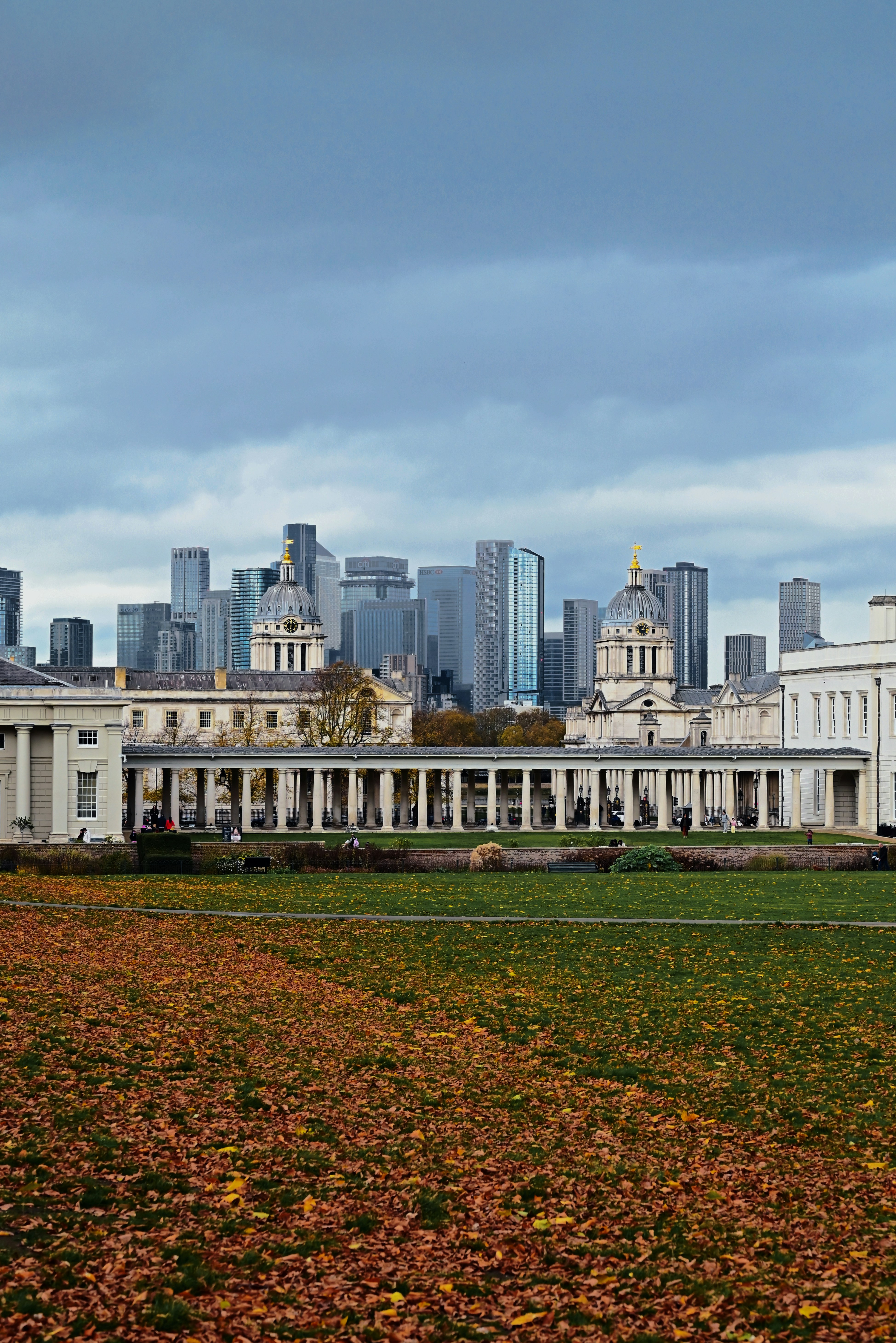 City skyline behind historic buildings and autumn leaves