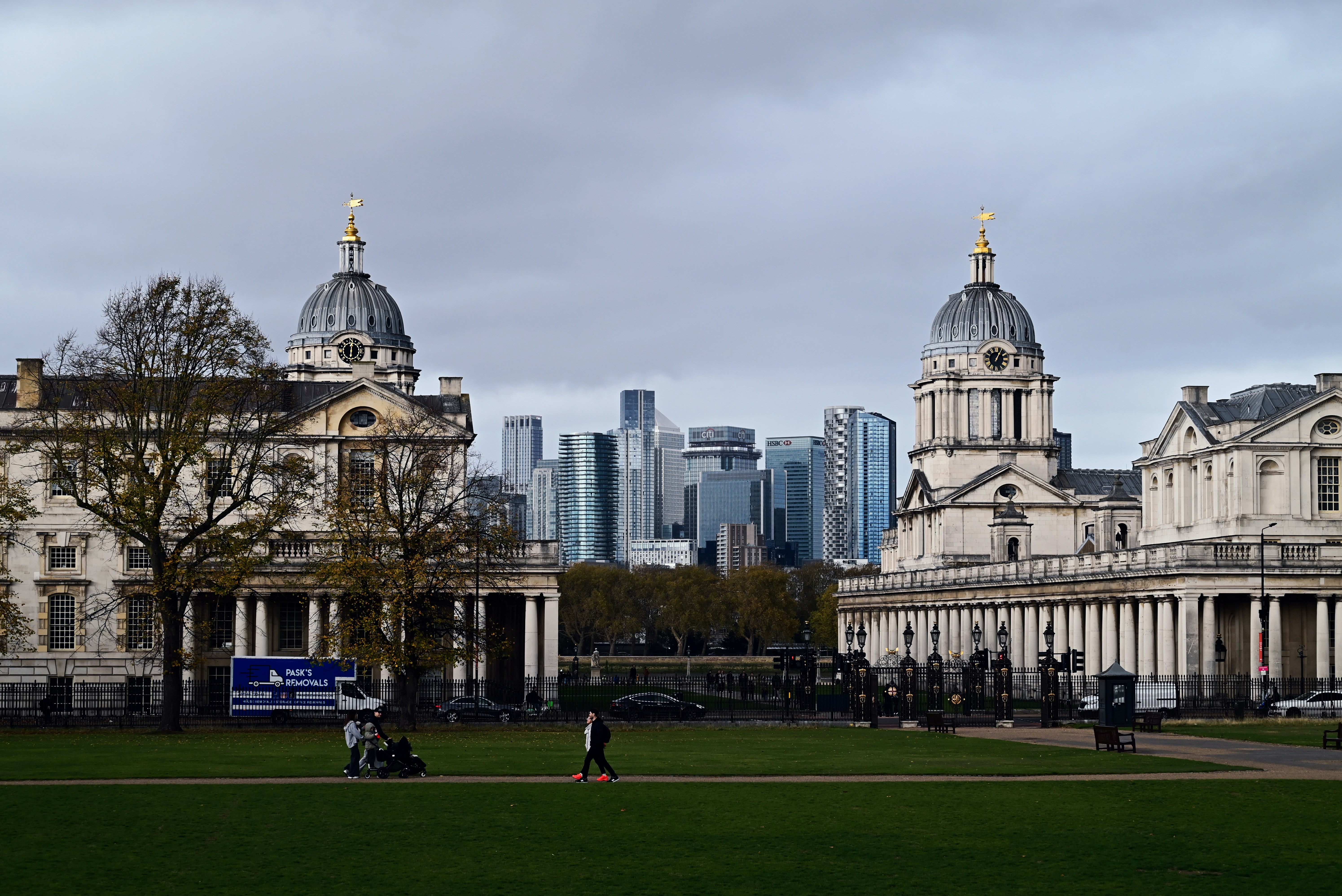 Historic buildings with modern city skyline behind