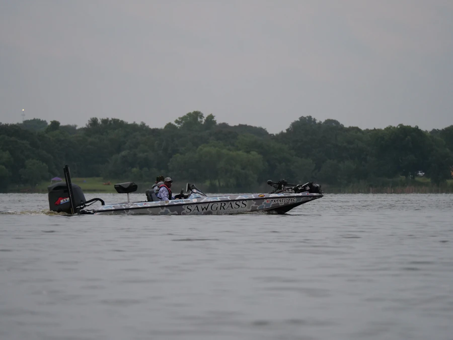 Fishing boat moving across a calm lake
