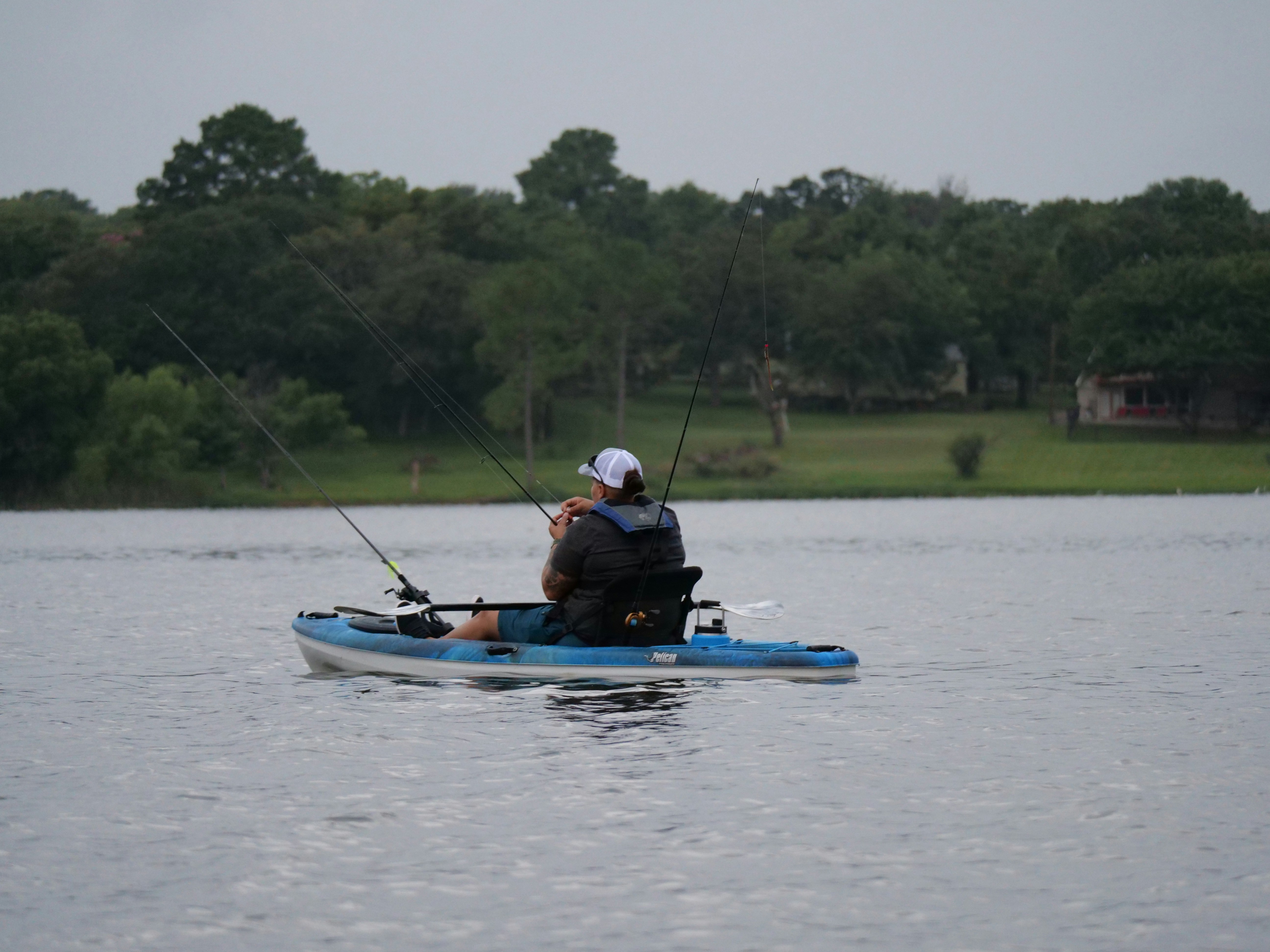 Man fishing from a kayak on a lake