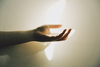 A hand reaching out with light