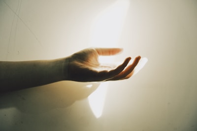 A hand reaching out with light