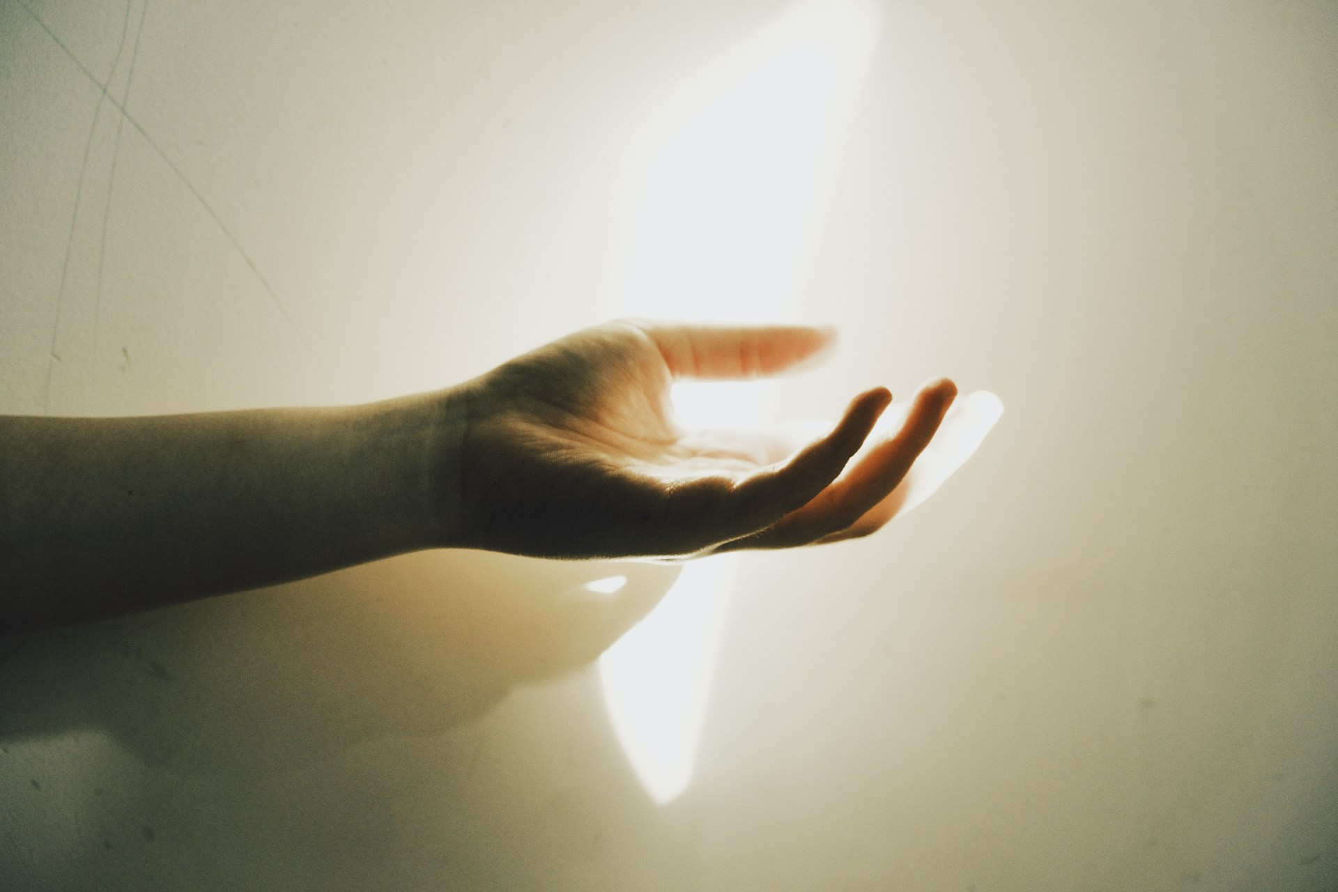 A hand reaching out with light