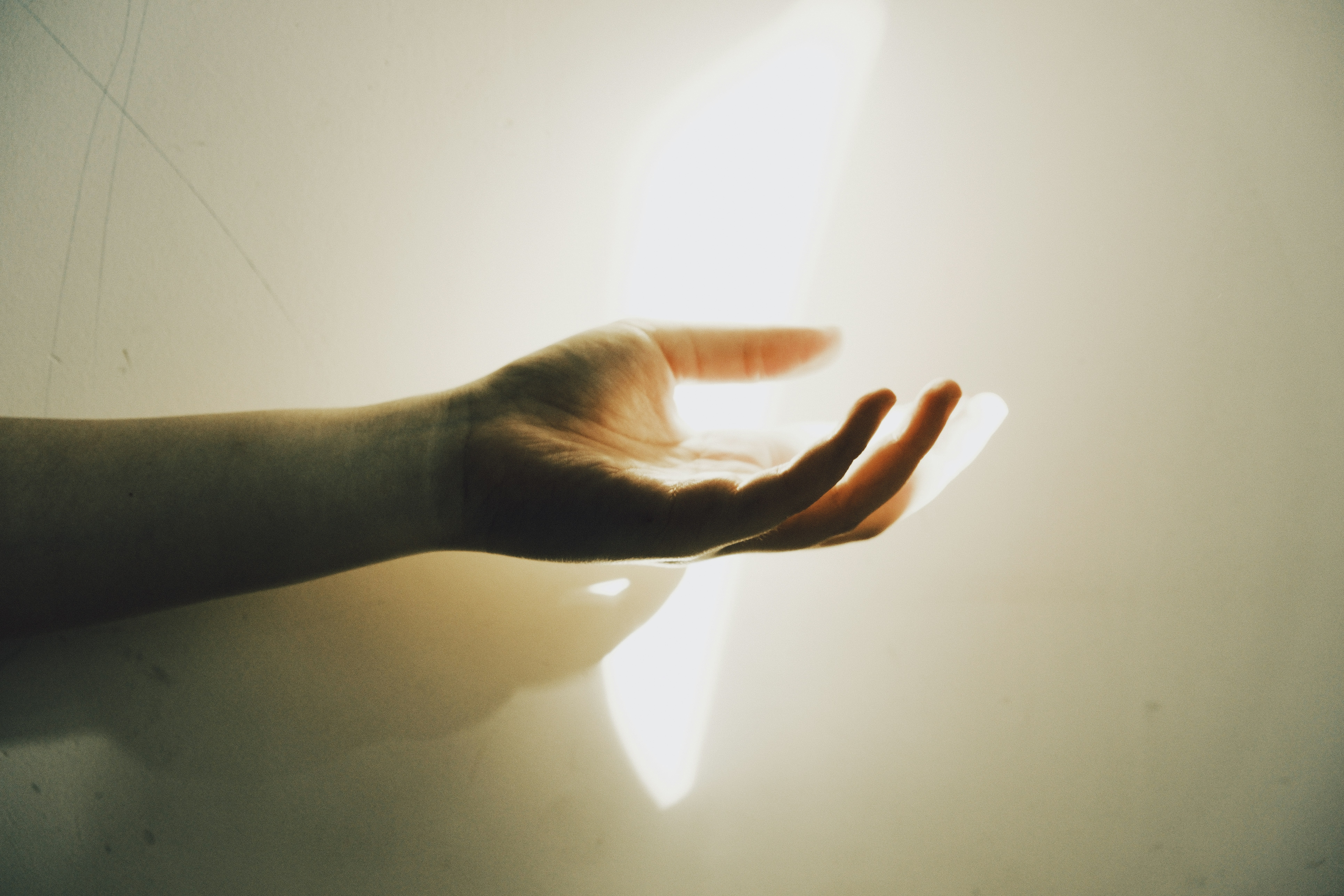 A hand reaching out with light