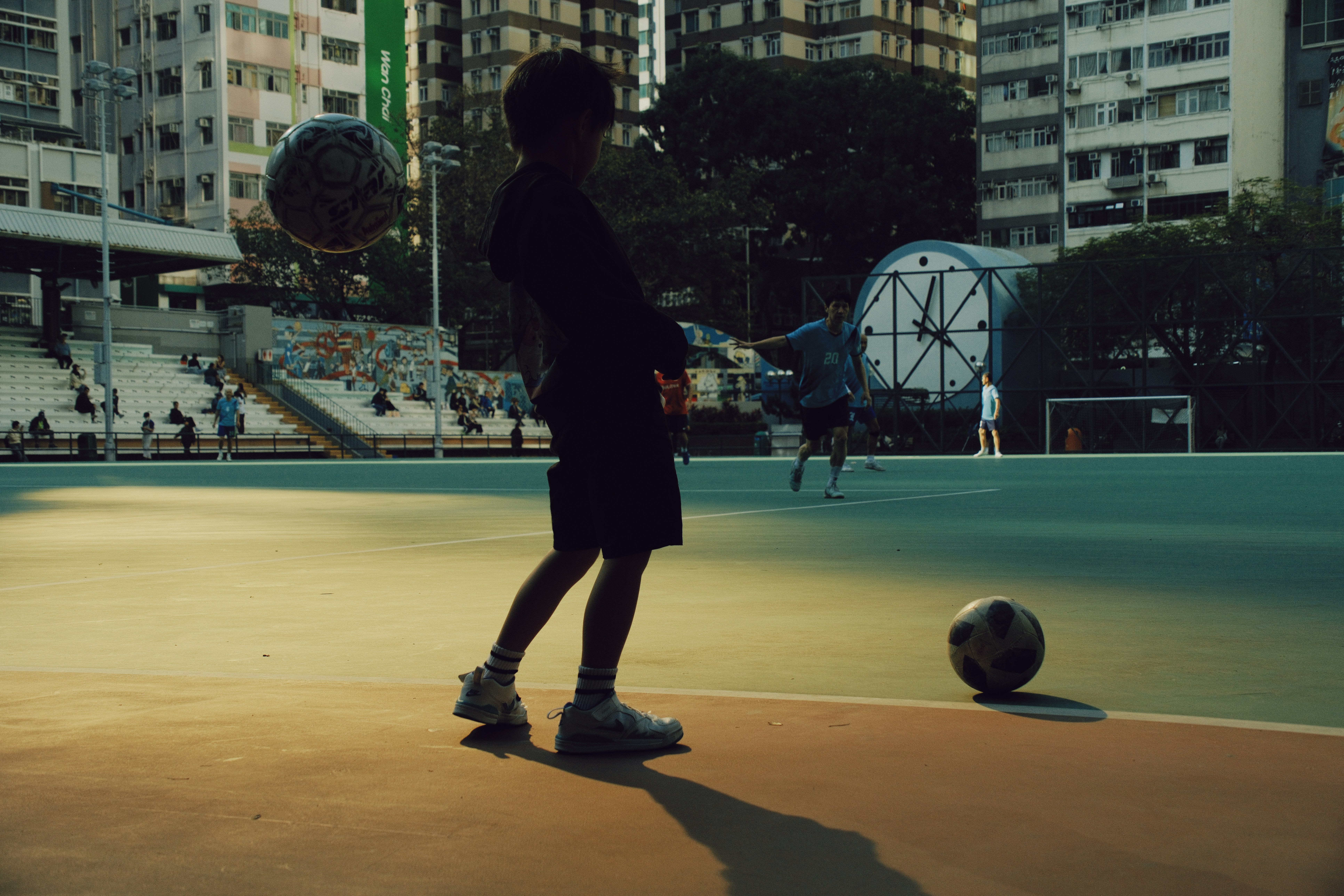 Boy practicing soccer drills on outdoor court