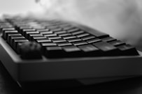 Close-up of a black mechanical keyboard with smoke.