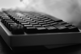 Close-up of a black mechanical keyboard with smoke.