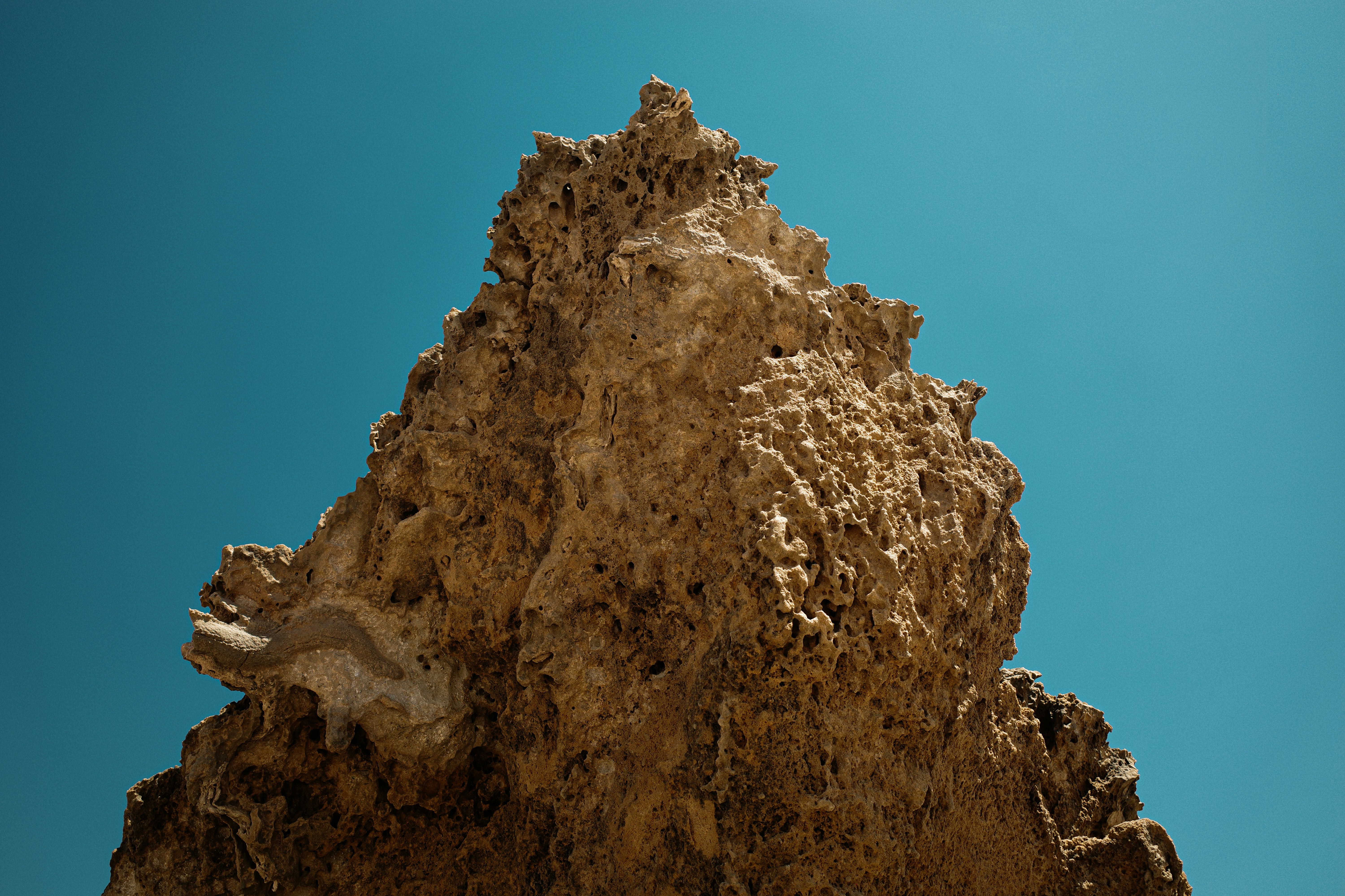 Jagged rock formation against a clear blue sky photo – Free Texture ...