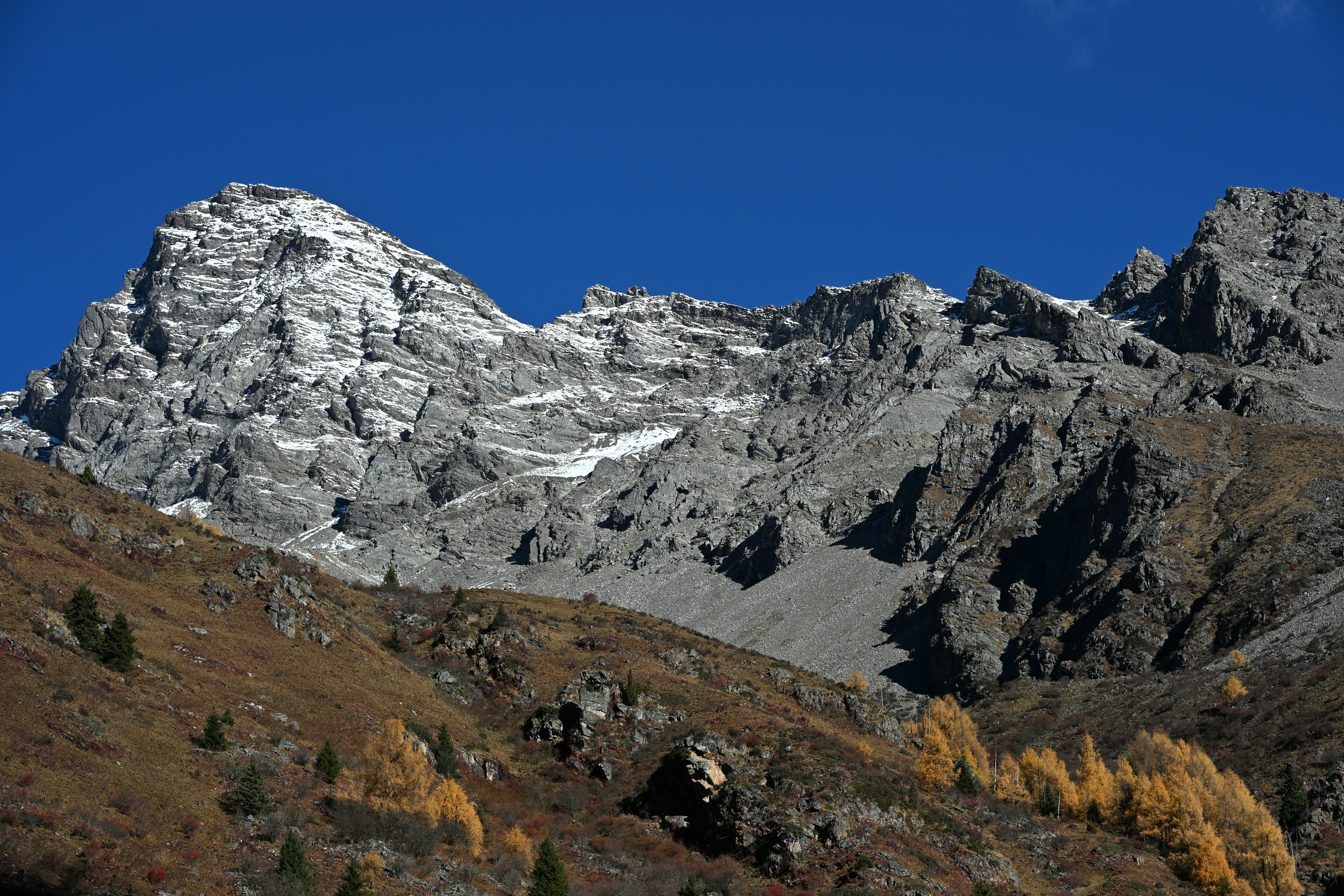 Snow-capped mountain peaks under a clear blue sky.