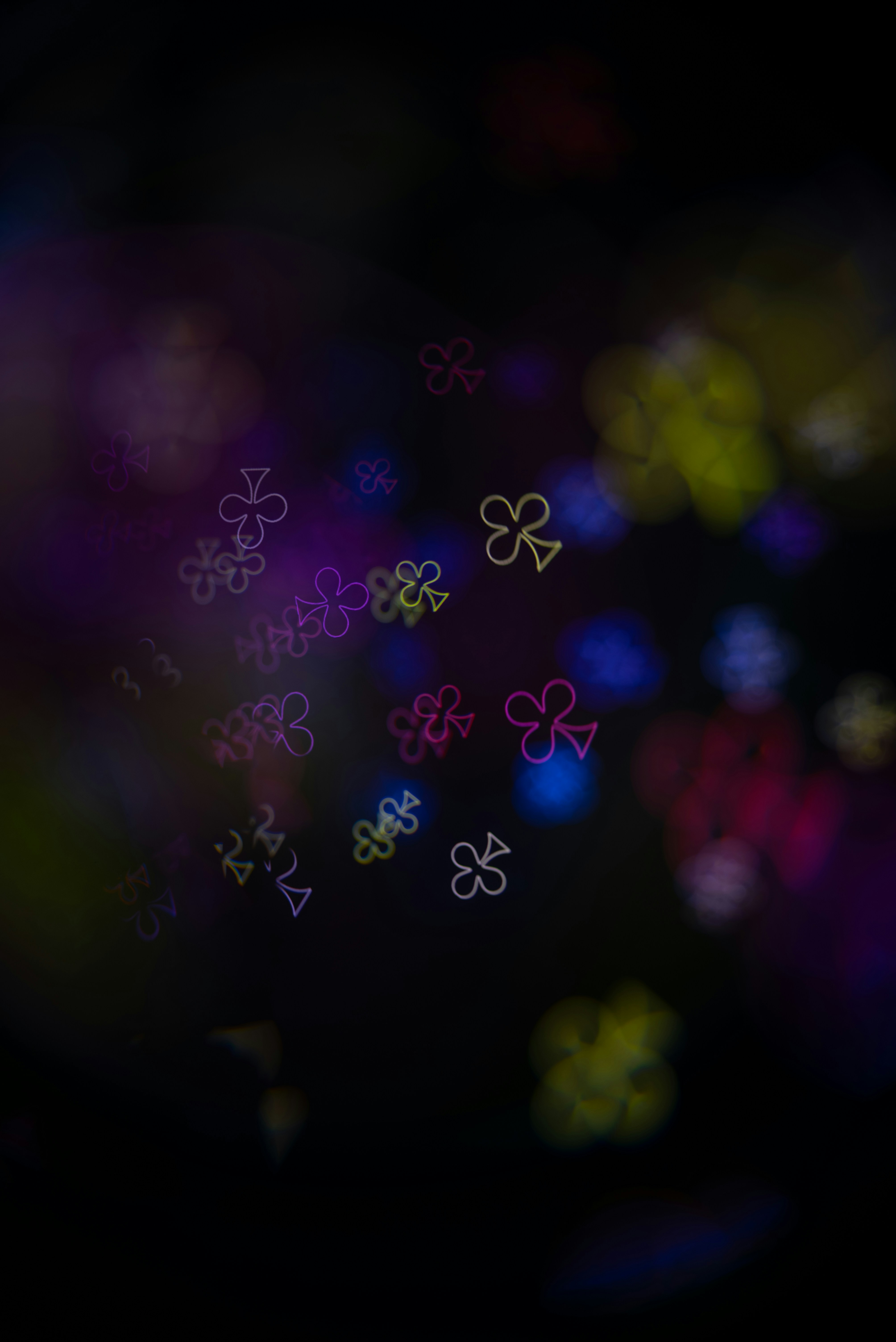 Abstract background with clover shapes and bokeh lights.