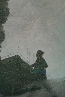 Silhouette of a person reflected in water