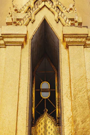 Intricate golden temple facade with ornate window