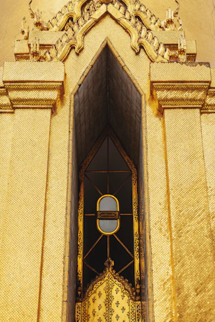 Intricate golden temple facade with ornate window