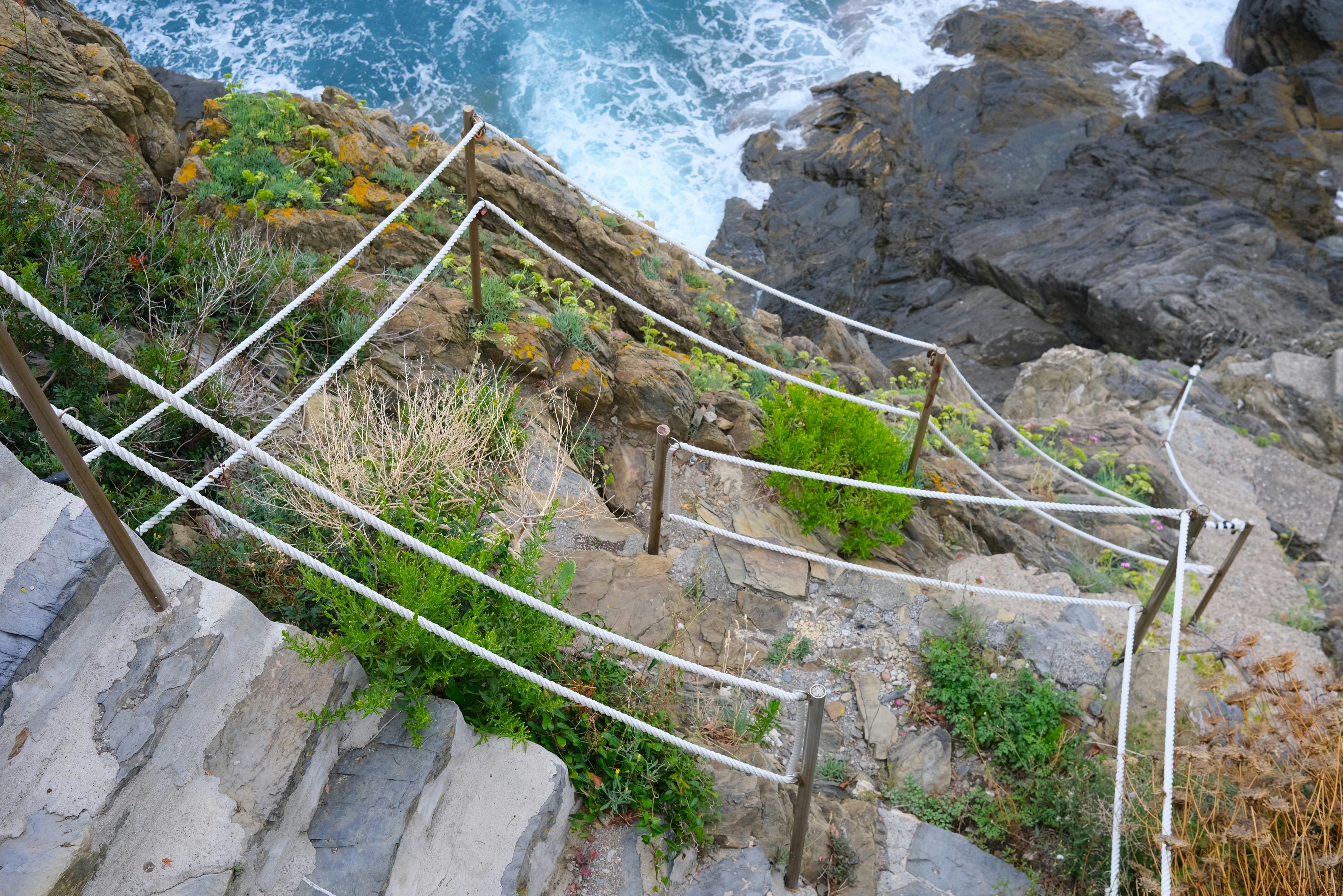 Stone steps with ropes lead down to the ocean. photo – Free Hiking ...