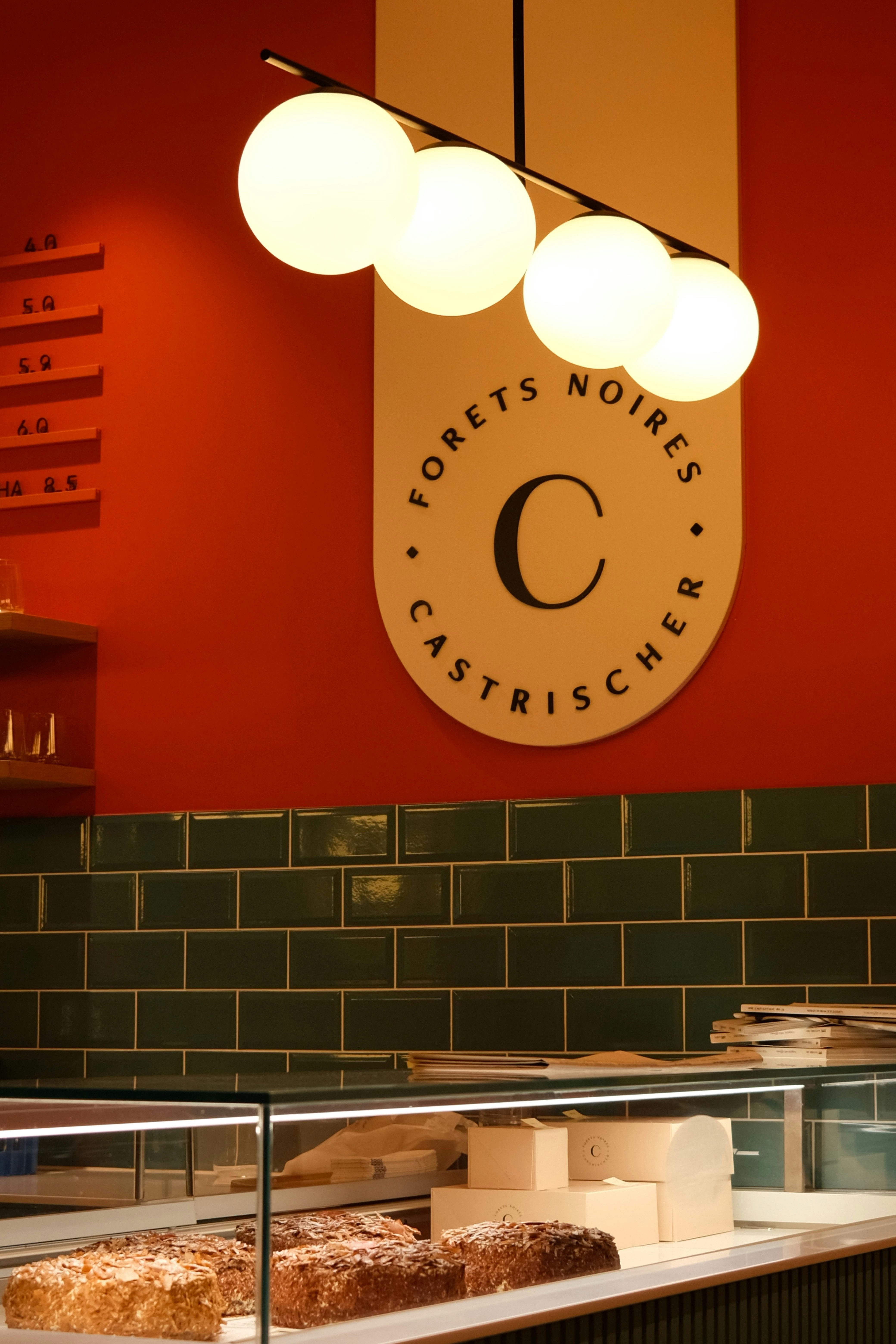 Modern cafe interior with baked goods and decor.