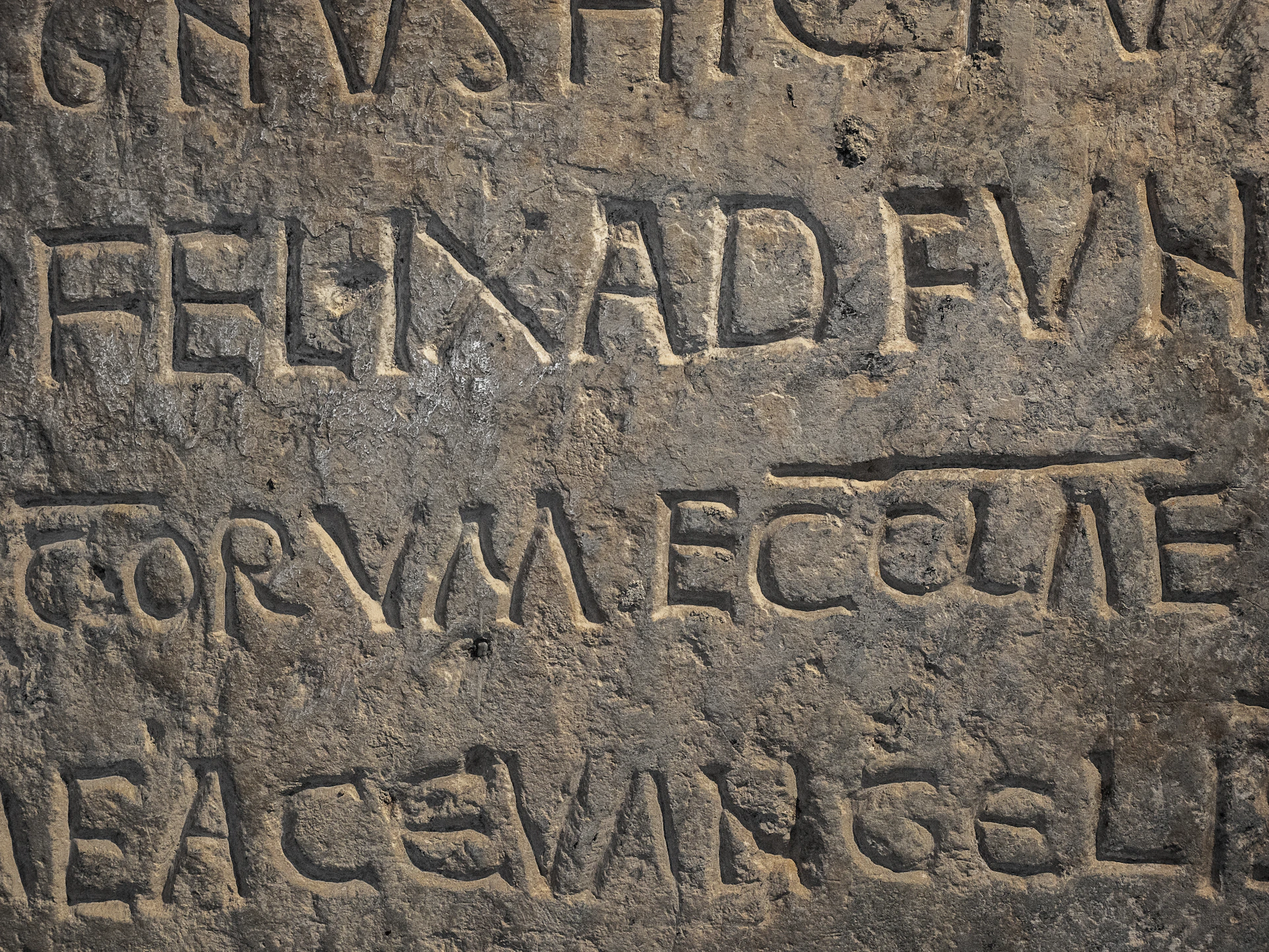 Close-up of ancient stone inscription with latin text.