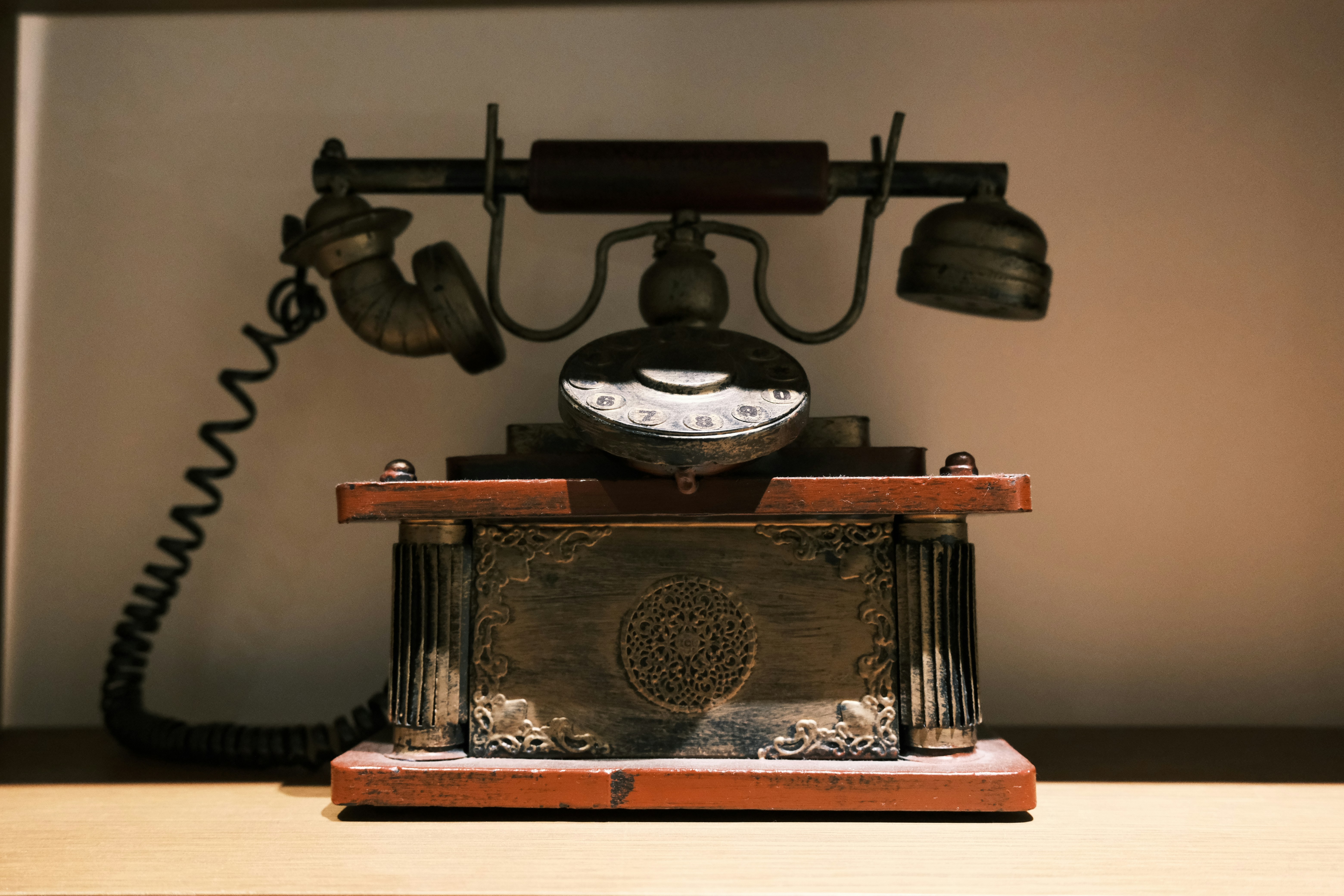 Antique rotary telephone on a wooden surface