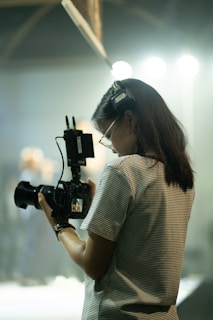 Woman filming with professional video camera