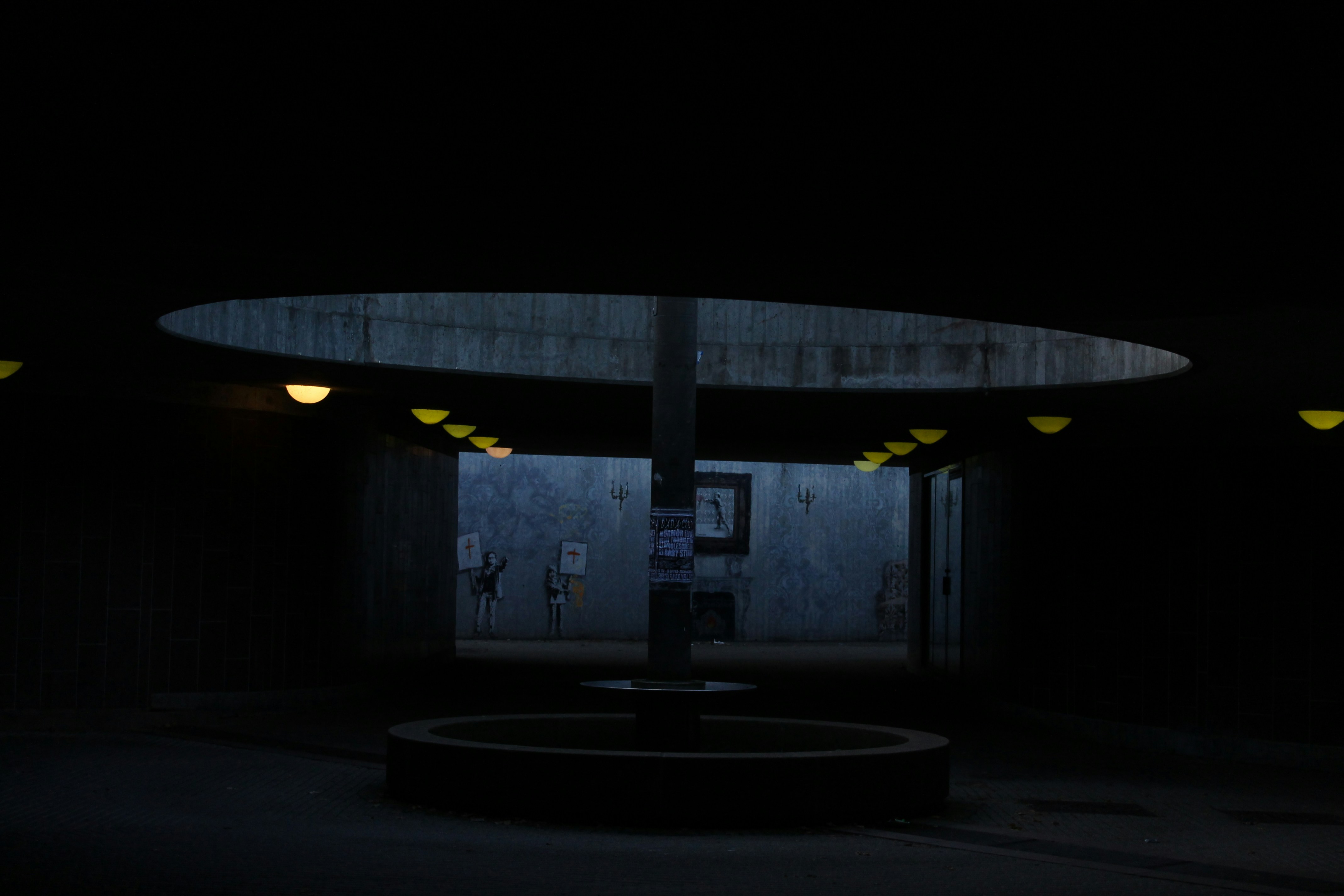 Dark underground passage with circular opening above