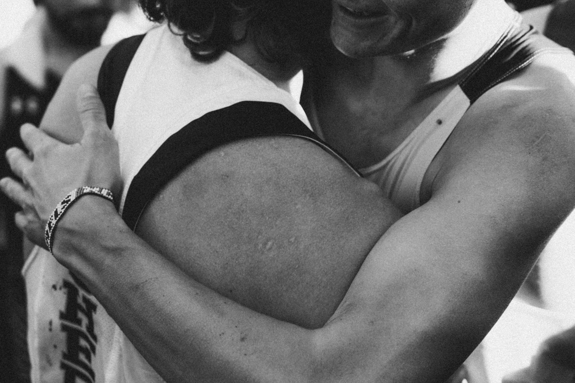 Two athletes embracing after a competition.