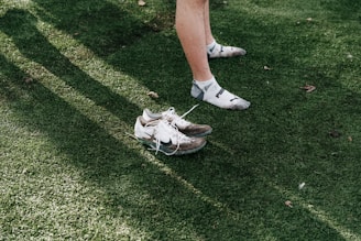 Pair of athletic shoes on green grass