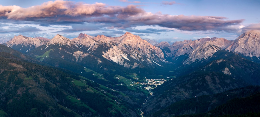 Alpine valley with dramatic mountain peaks rising above