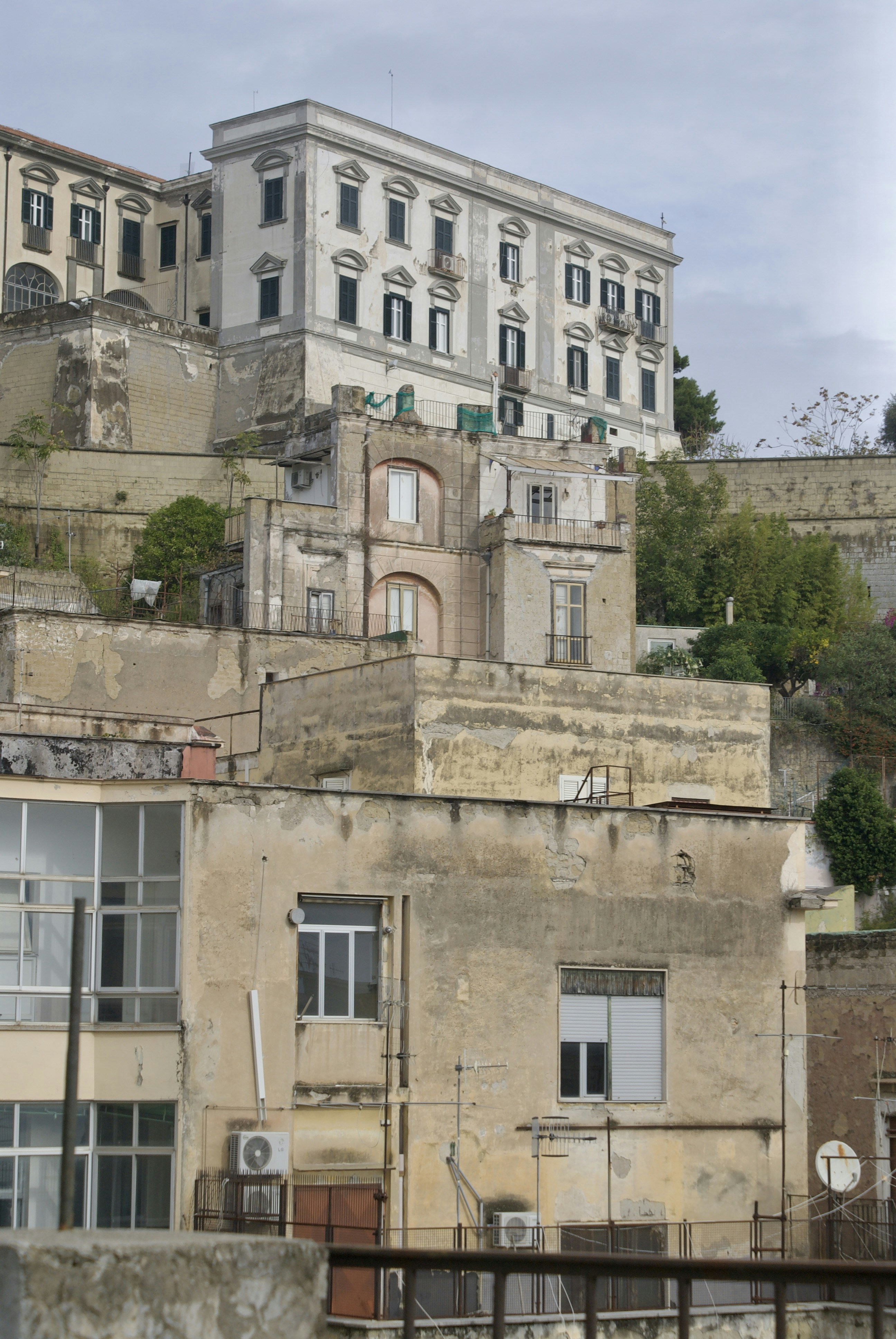 Old buildings on a hillside under a cloudy sky