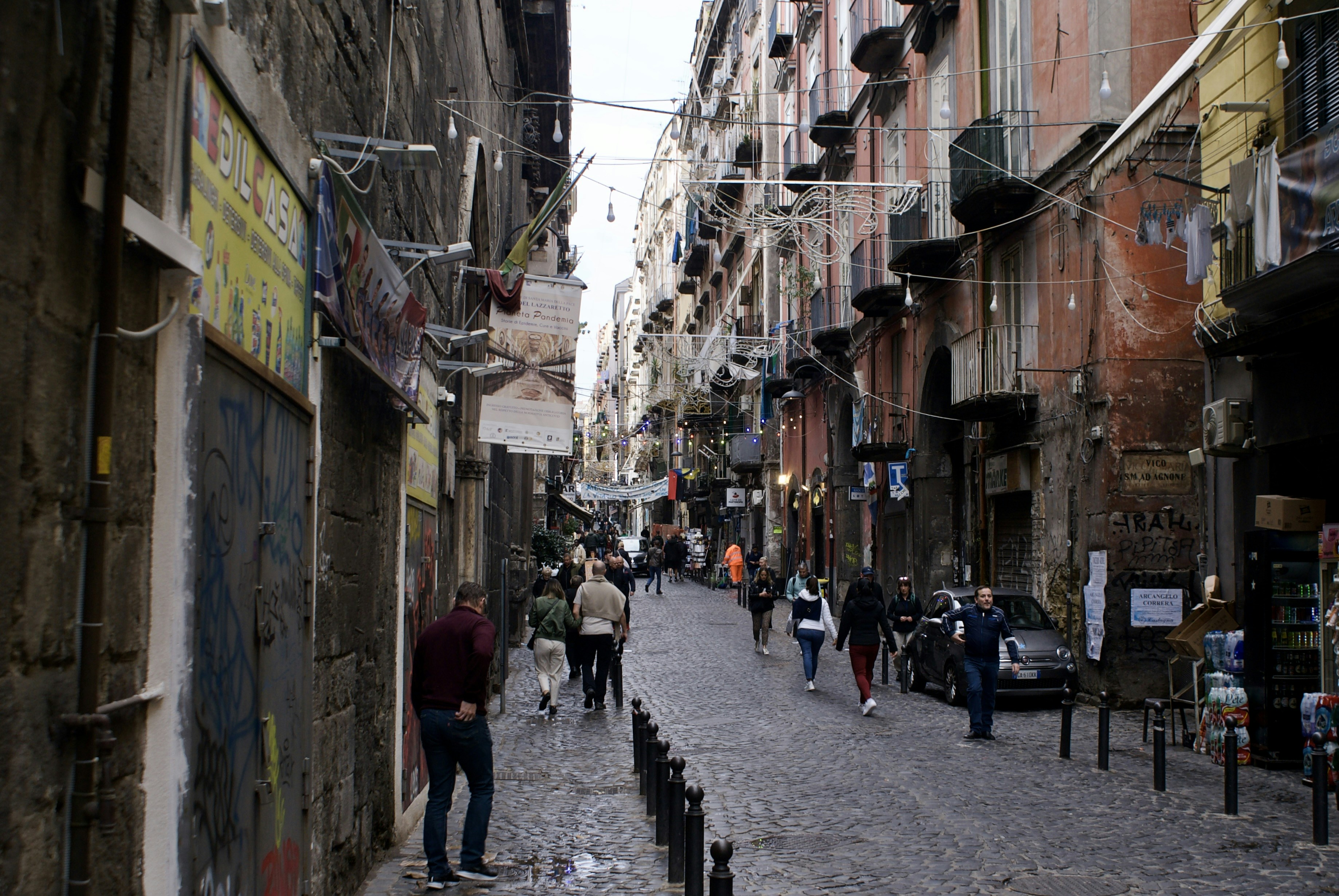People walking down a narrow european street