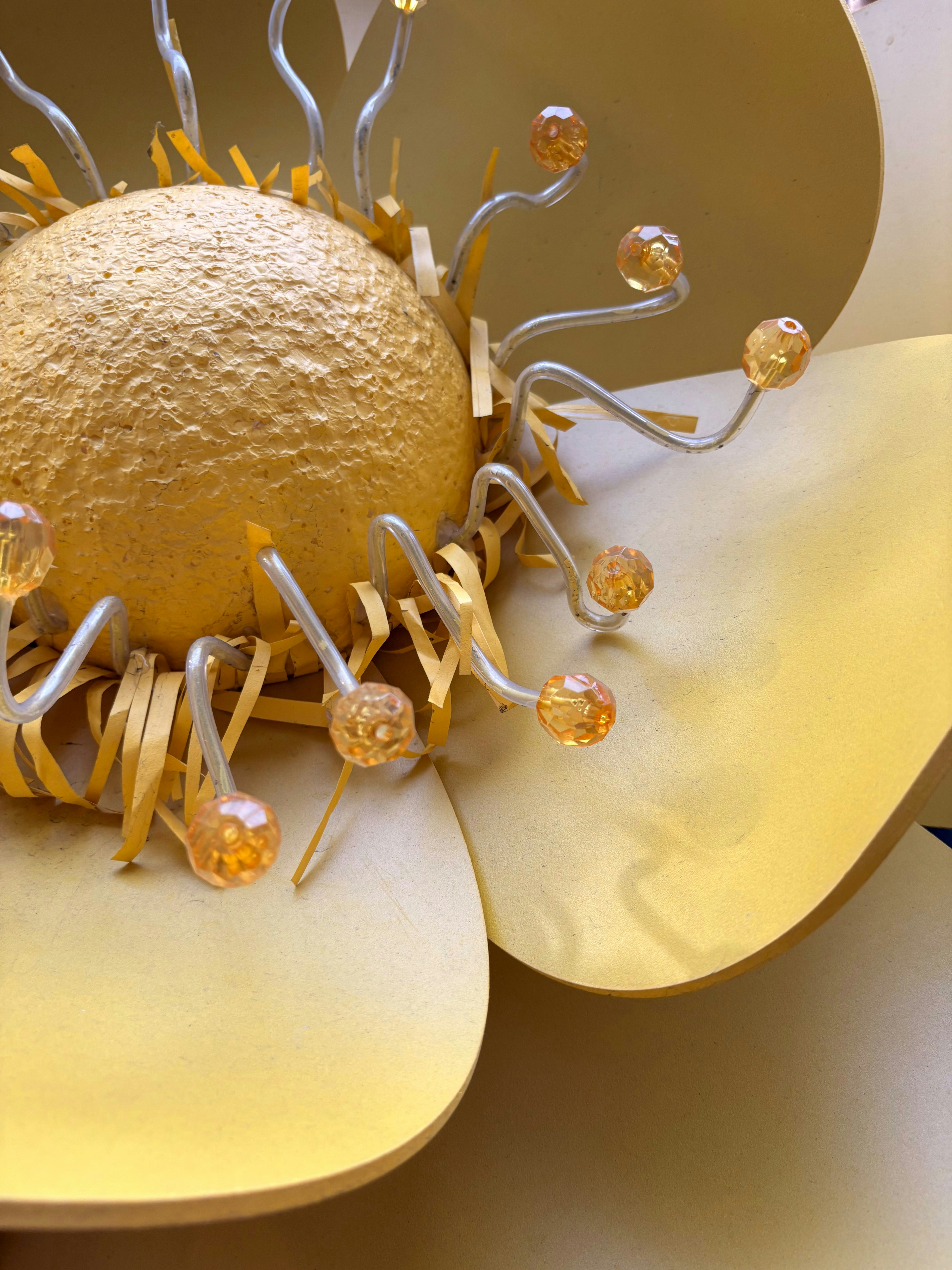 Close-up of a golden flower decoration with beads