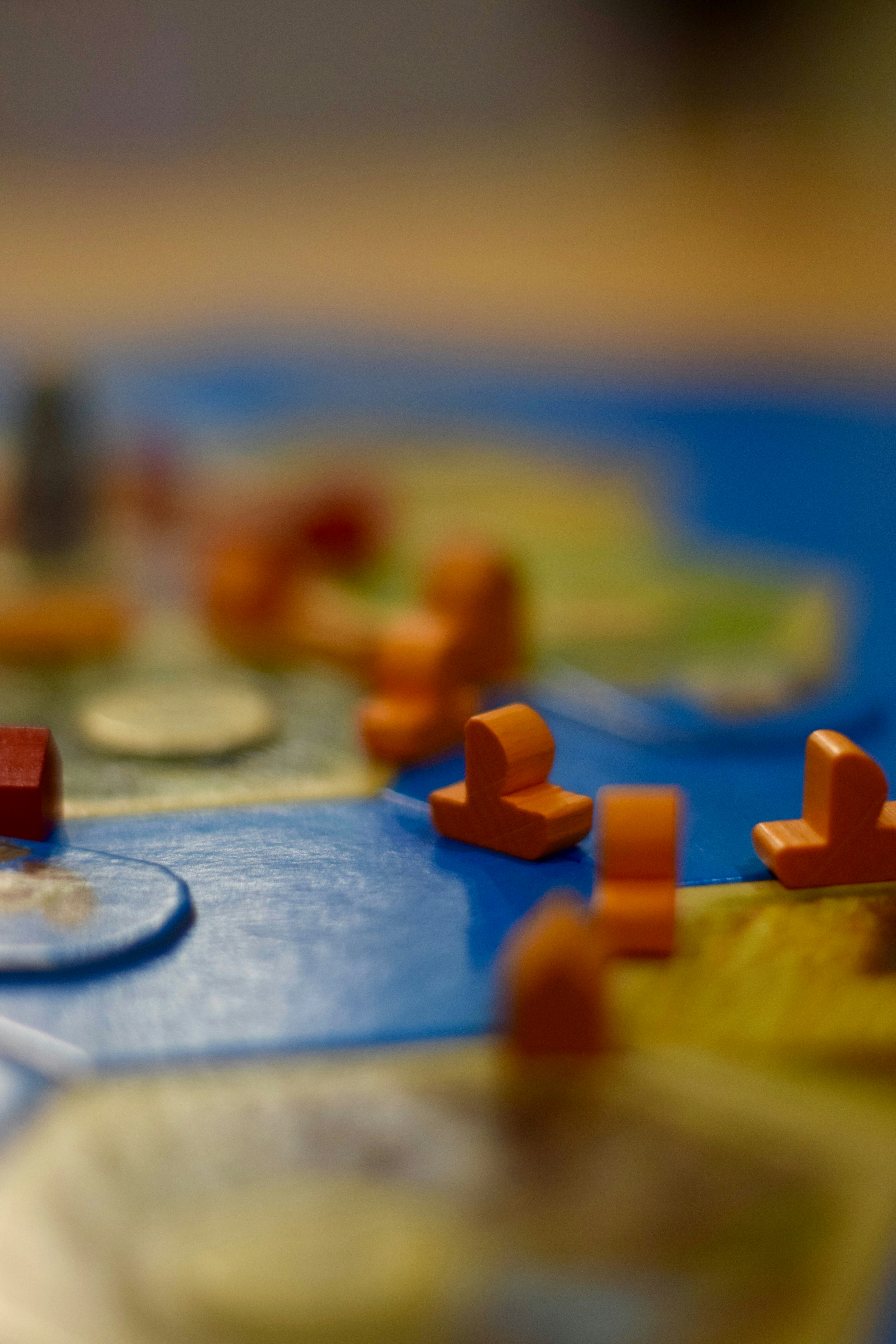 Close-up of wooden game pieces on a board.