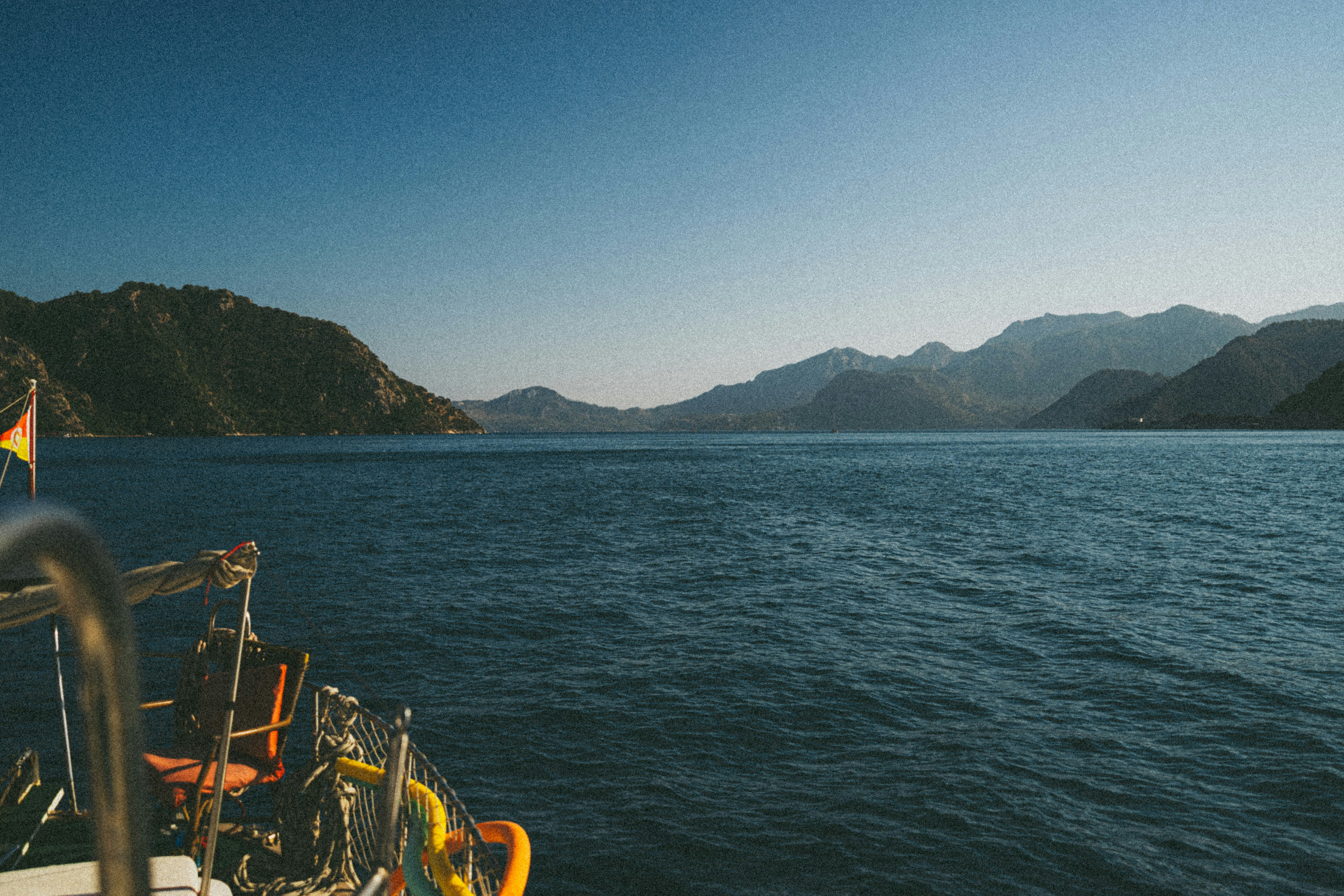 Calm blue sea with mountains in the distance